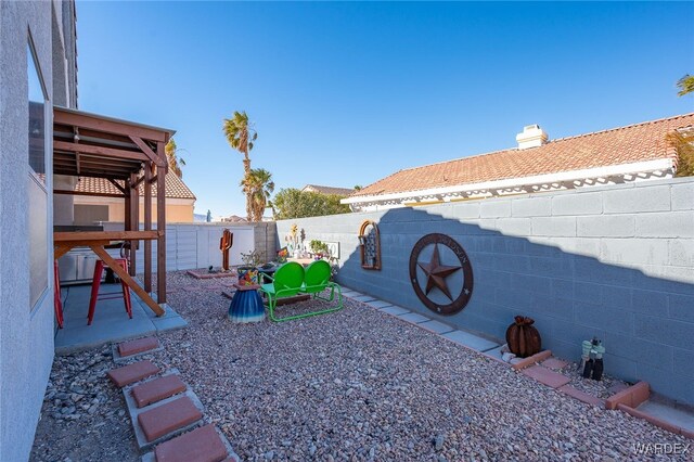 view of yard with a patio area and a fenced backyard