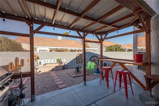 view of patio / terrace with a fenced backyard, a mountain view, and a bar