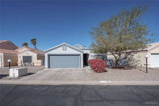 view of front of property with concrete driveway, an attached garage, and stucco siding