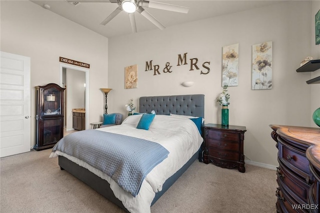 bedroom with light carpet, ceiling fan, baseboards, and vaulted ceiling