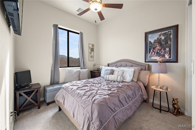 bedroom featuring baseboards, ceiling fan, visible vents, and light colored carpet