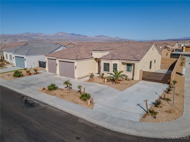 view of front of home with a garage, concrete driveway, a tiled roof, and stucco siding