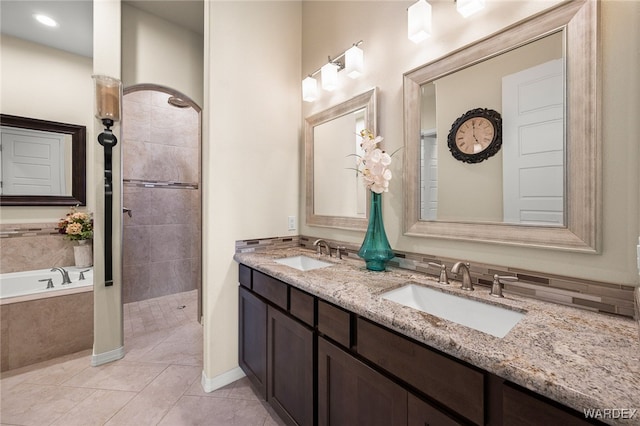 bathroom with tile patterned floors, a walk in shower, a sink, and a bath