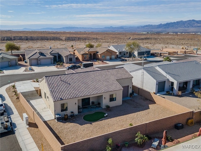 birds eye view of property with a mountain view and a residential view