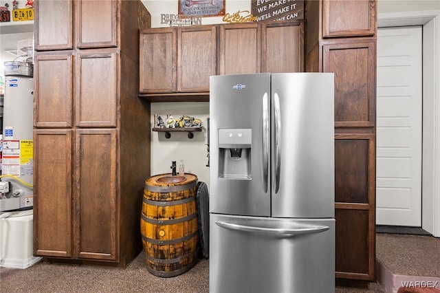 kitchen featuring stainless steel refrigerator with ice dispenser and gas water heater