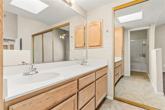 1951 E Oatman Pl, Mohave Valley, AZ 86440 - bathroom with a skylight, double vanity, tile patterned flooring, and a ceiling fan
