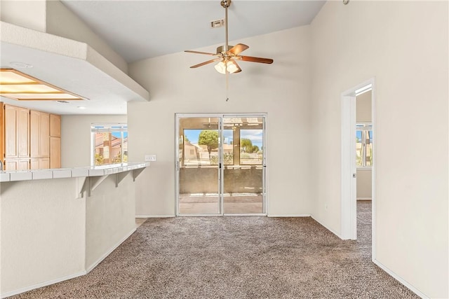 1951 E Oatman Pl, Mohave Valley, AZ 86440 - unfurnished living room with carpet floors, ceiling fan, and vaulted ceiling