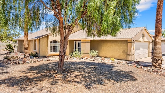 1951 E Oatman Pl, Mohave Valley, AZ 86440 - single story home with stucco siding, an attached garage, and concrete driveway