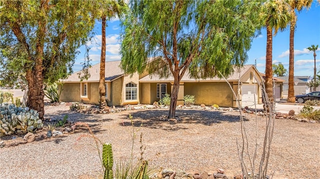 1951 E Oatman Pl, Mohave Valley, AZ 86440 - ranch-style home with stucco siding, an attached garage, and driveway
