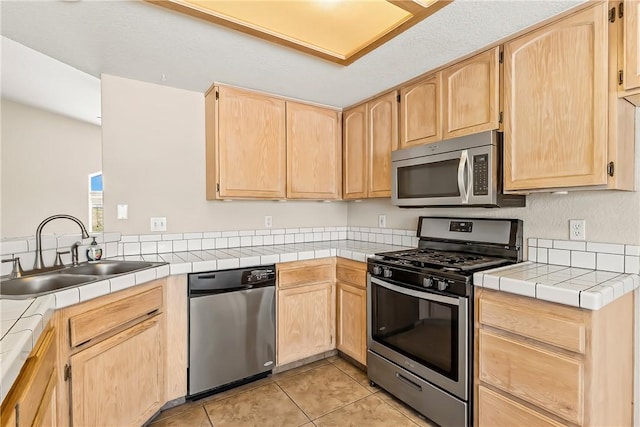 1951 E Oatman Pl, Mohave Valley, AZ 86440 - kitchen with appliances with stainless steel finishes, light brown cabinetry, and light tile patterned flooring