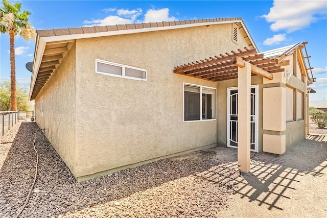 1951 E Oatman Pl, Mohave Valley, AZ 86440 - rear view of property with a pergola, stucco siding, a patio, and a tile roof