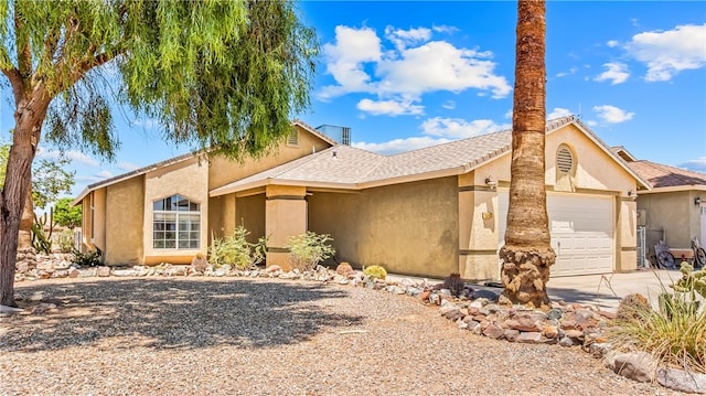 1951 E Oatman Pl, Mohave Valley, AZ 86440 - view of front of house with stucco siding, concrete driveway, and a garage