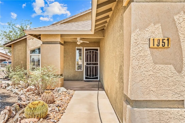 1951 E Oatman Pl, Mohave Valley, AZ 86440 - view of exterior entry with a ceiling fan and stucco siding