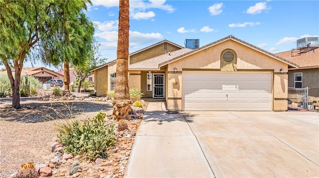 1951 E Oatman Pl, Mohave Valley, AZ 86440 - view of front of property featuring stucco siding, an attached garage, and driveway