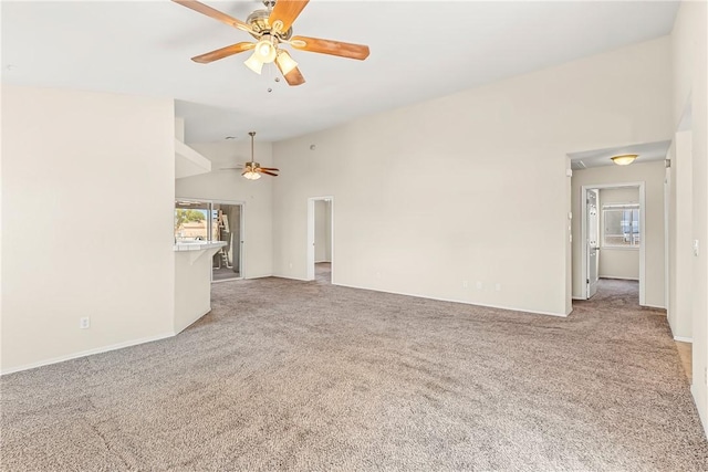 1951 E Oatman Pl, Mohave Valley, AZ 86440 - unfurnished living room featuring a ceiling fan, light carpet, and vaulted ceiling
