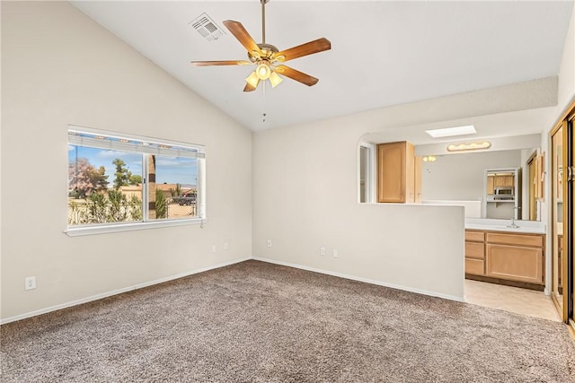 1951 E Oatman Pl, Mohave Valley, AZ 86440 - unfurnished living room featuring light colored carpet, a ceiling fan, and vaulted ceiling