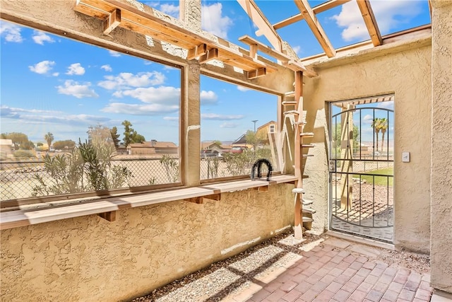 1951 E Oatman Pl, Mohave Valley, AZ 86440 - unfurnished sunroom with a textured wall and brick flooring