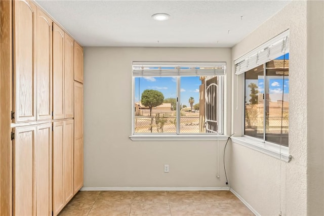 1951 E Oatman Pl, Mohave Valley, AZ 86440 - unfurnished bedroom featuring baseboards and light tile patterned flooring