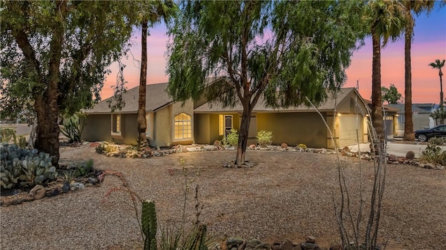 1951 E Oatman Pl, Mohave Valley, AZ 86440 - view of front of home with driveway, an attached garage, and stucco siding