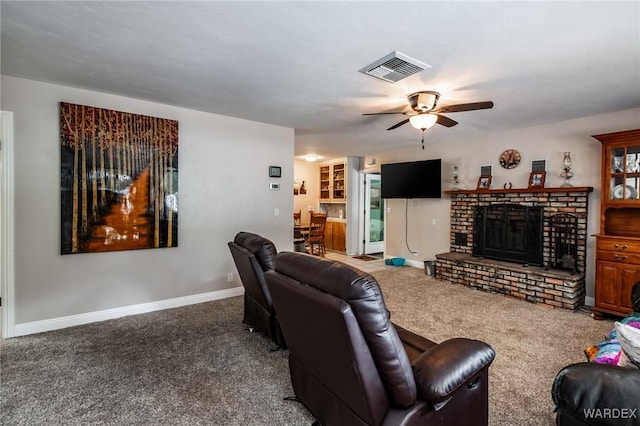 living area with carpet, baseboards, visible vents, ceiling fan, and a brick fireplace