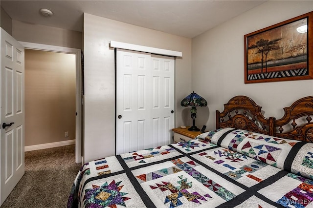 bedroom with a closet, baseboards, and carpet floors