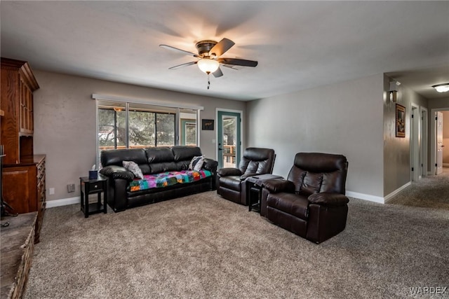 carpeted living room featuring baseboards and ceiling fan