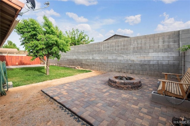 view of patio / terrace featuring a fenced backyard and an outdoor fire pit