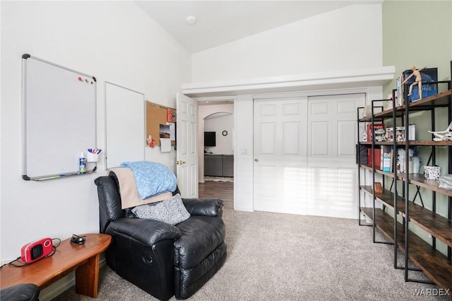 living area featuring arched walkways, carpet, and lofted ceiling