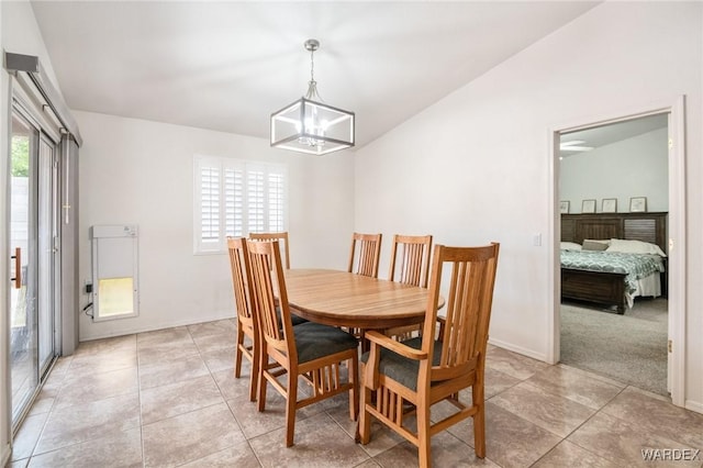 dining space featuring light tile patterned floors and baseboards
