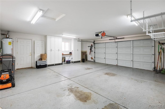 garage with a garage door opener and gas water heater