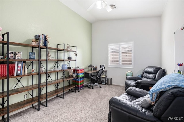 carpeted office with ceiling fan, visible vents, baseboards, and lofted ceiling