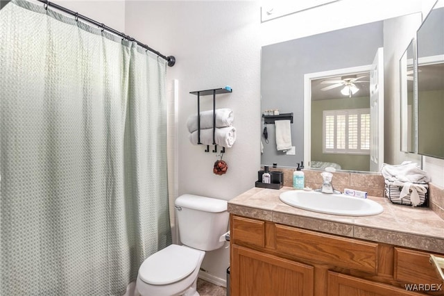 bathroom with toilet, ceiling fan, a shower with shower curtain, and vanity