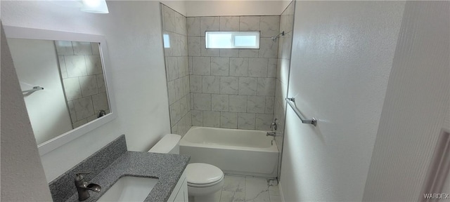 bathroom featuring marble finish floor, bathing tub / shower combination, toilet, and vanity