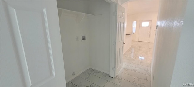 hallway featuring marble finish floor and baseboards