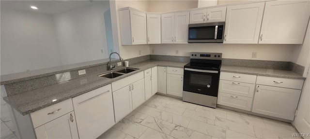 kitchen with marble finish floor, appliances with stainless steel finishes, white cabinets, and a sink