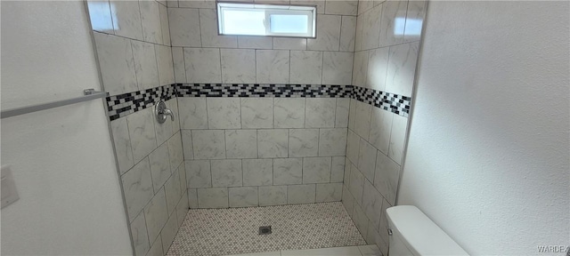 bathroom featuring a stall shower and toilet