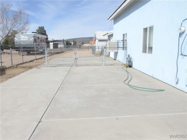 view of sport court with a gate and fence