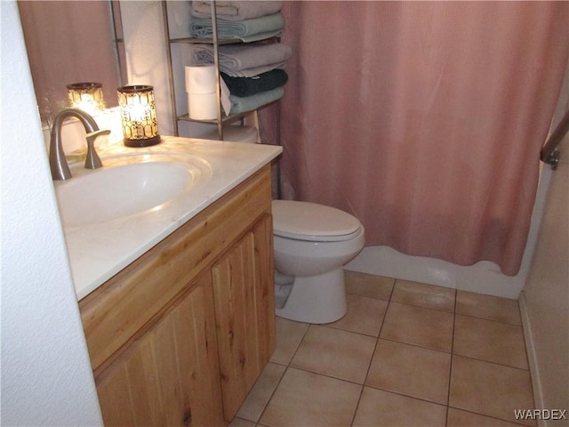 bathroom with toilet, tile patterned flooring, a shower with shower curtain, and vanity