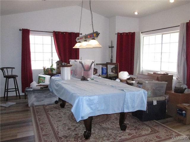 bedroom with lofted ceiling and wood finished floors