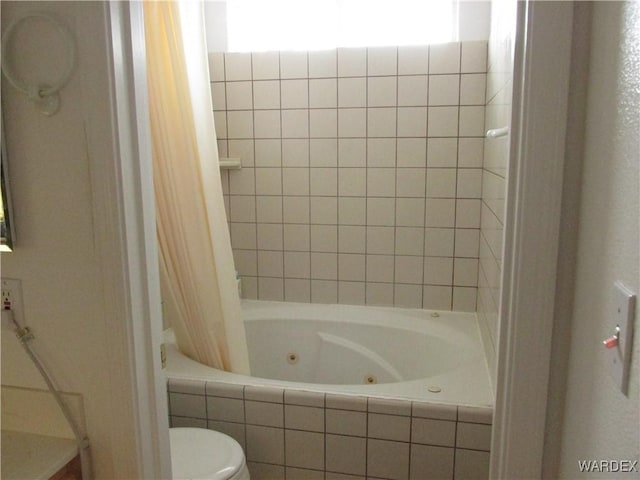 bathroom featuring toilet and a combined bath / shower with jetted tub