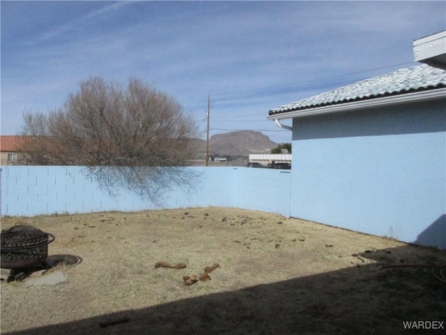 view of yard with an outdoor fire pit and a fenced backyard