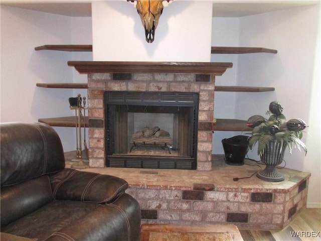 room details with wood finished floors and a stone fireplace