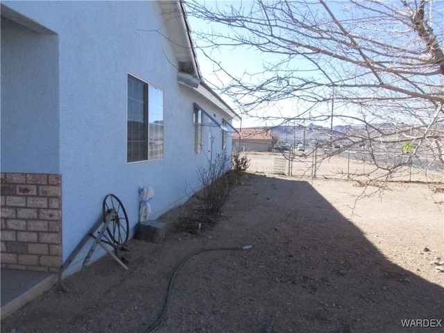 view of side of home featuring stucco siding