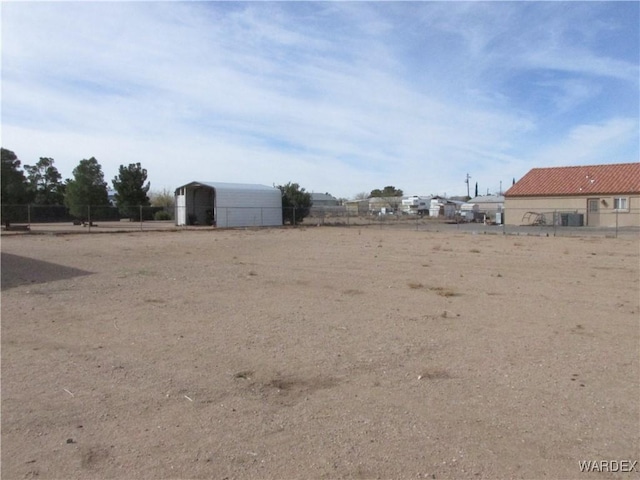 view of yard with fence and a detached carport