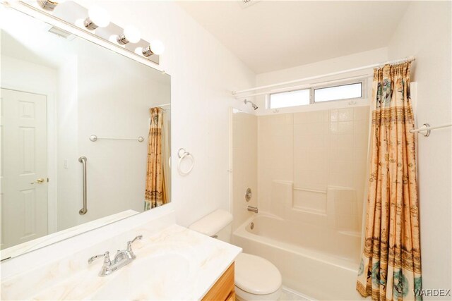 bathroom featuring shower / bath combination with curtain, vanity, and toilet