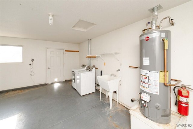 laundry room featuring a sink, laundry area, gas water heater, and washing machine and clothes dryer