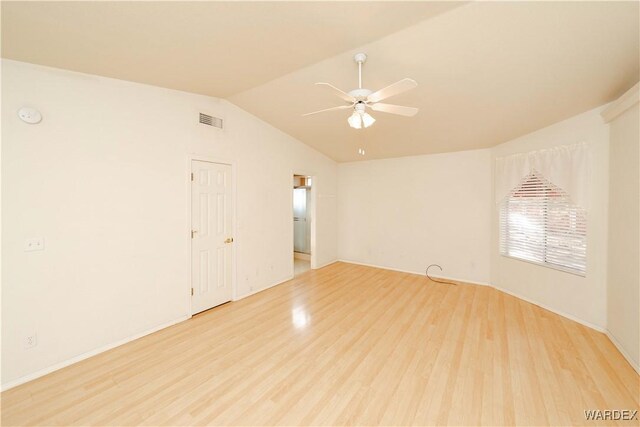 unfurnished room with light wood-style flooring, visible vents, vaulted ceiling, and a ceiling fan