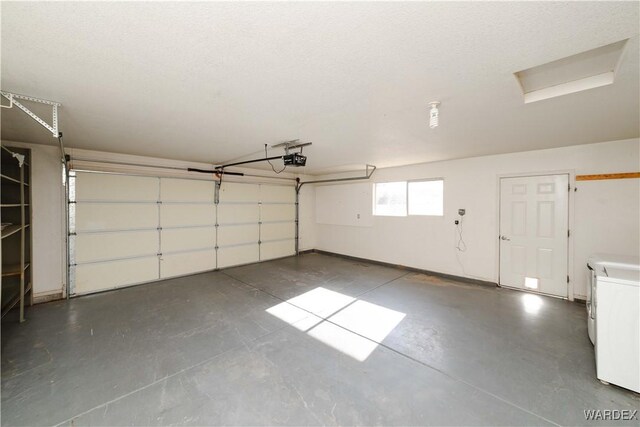 garage with washer / clothes dryer and a garage door opener