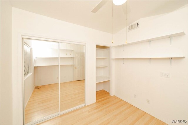 interior space with visible vents, wood finished floors, and a ceiling fan