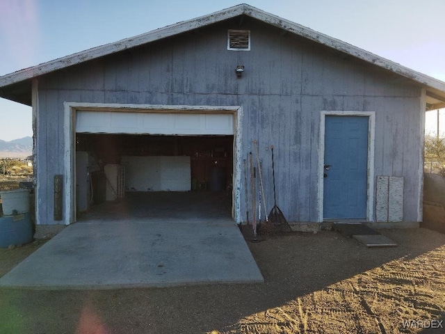 view of outbuilding with a garage and an outdoor structure